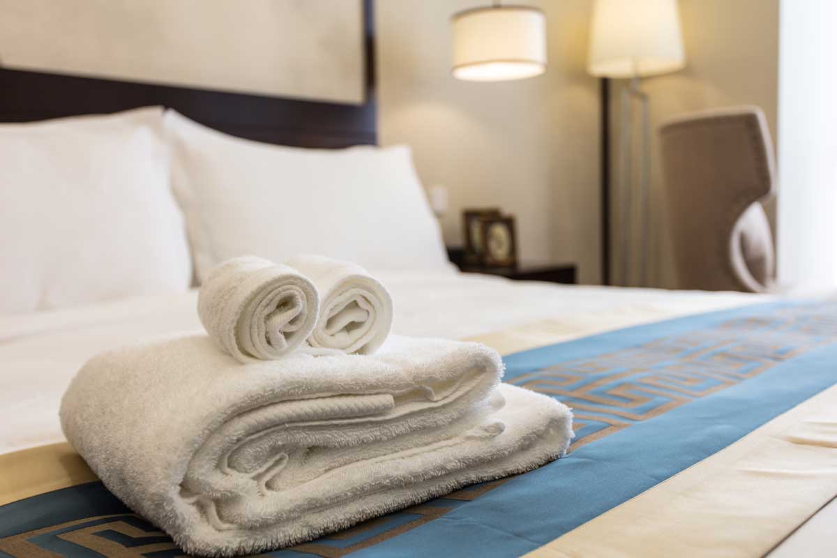 Laundered towels on hotel bed